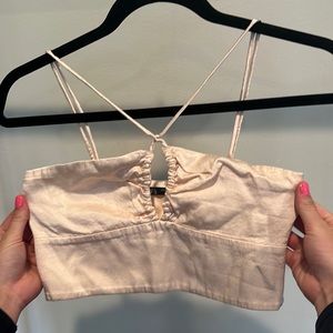 Light pink, silky crop top. Beautiful straps and cut out on front. Size XS